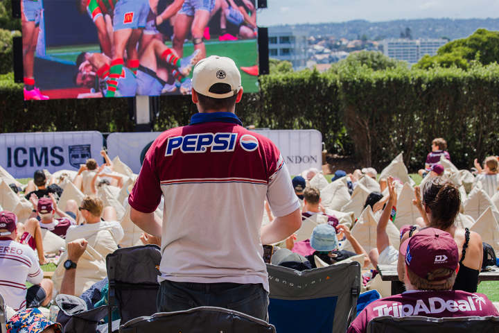 a group of people sitting at a table with a cake