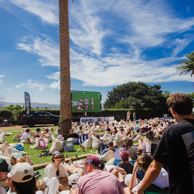 a group of people sitting at a table in front of a crowd